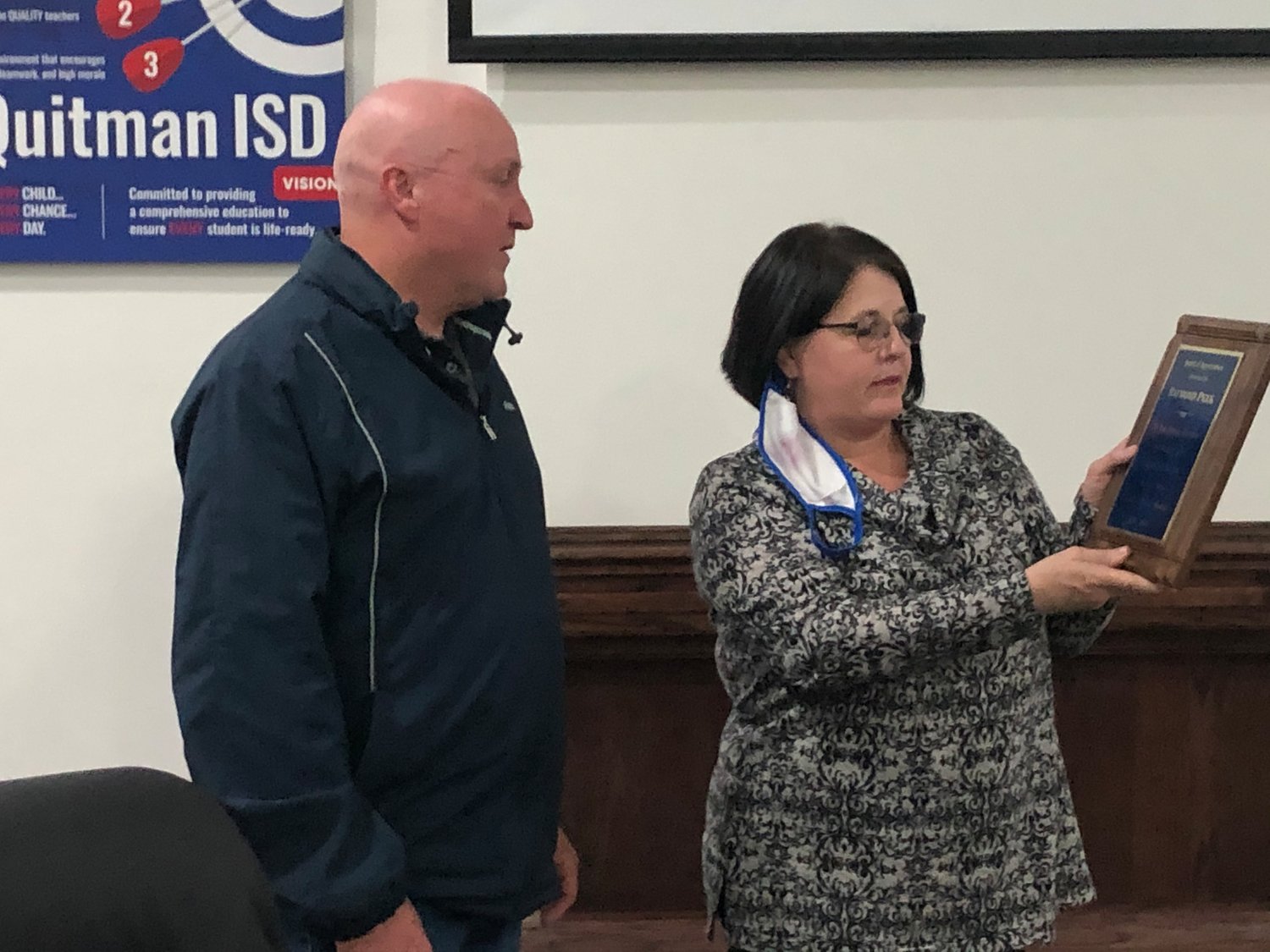 Outgoing board member Raymond Peek receives a plaque from Quitman ISD Superintendent Rhonda Turner honoring him for his years of service to the district.